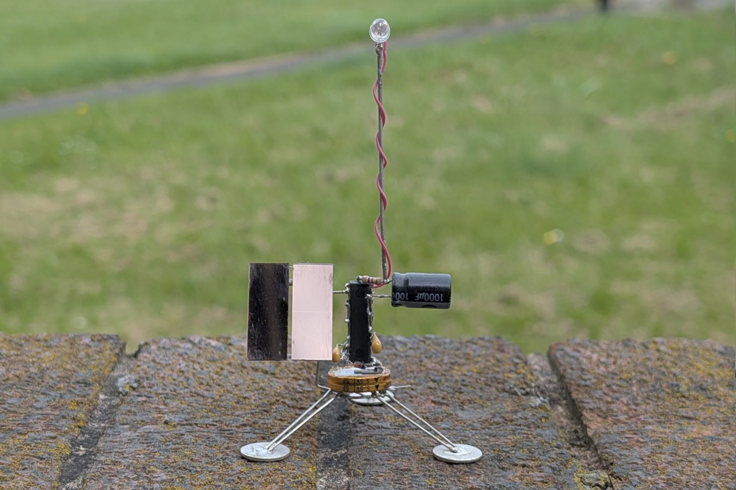 Satellite-like robot with flashing LED.