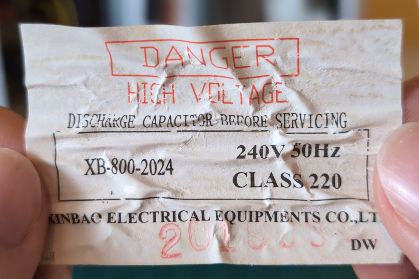 A warning label for the high voltage capacitor.