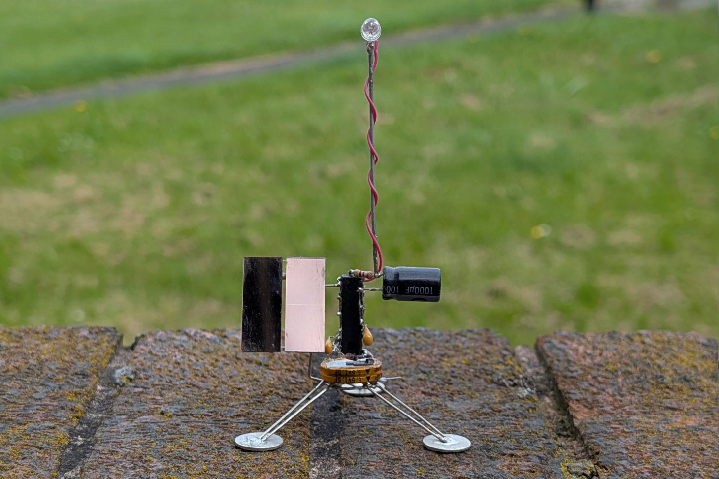 Satellite-like robot with flashing LED.