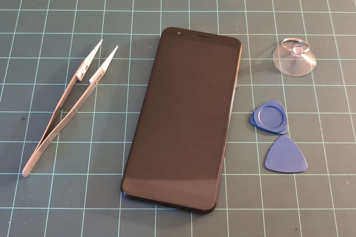 Phone on workbench ready for disassembly.