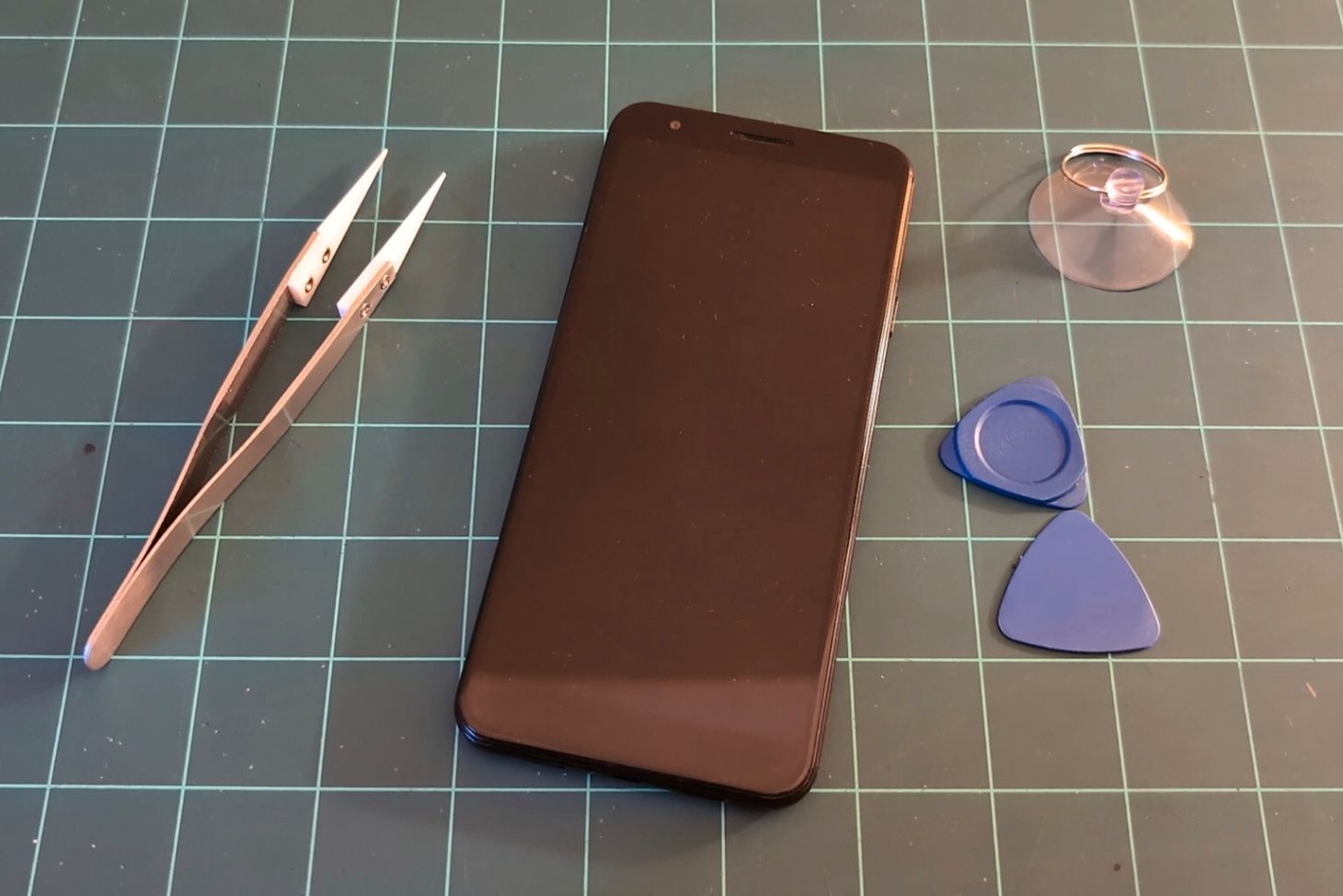 Phone on workbench ready for disassembly.